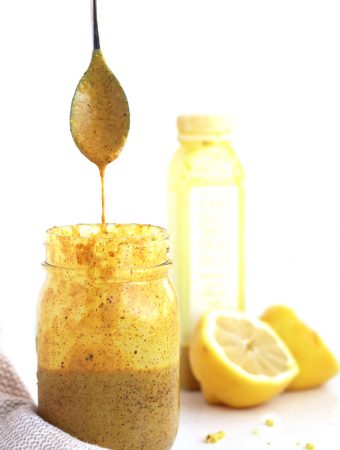 almond turmeric dressing with a spoon dripping with sauce.