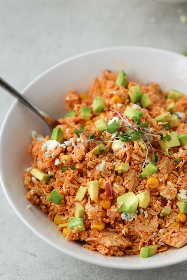 buffalo quinoa salad in bowl with a fork