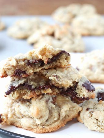 oatmeal cookies with chocolate chips melting out of them.