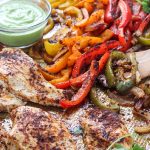 These one sheet pan chicken fajitas with avocado sauce can be made in under 30 minutes and is an easy clean up! Peppers, avocado and low sodium fajita seasoning makes for a heart healthy meal. | mealswithmaggie.com #hearthealthy #onesheetpandinner #onesheetpanchickenfajitas #avocadosauce #lowsodiumfajitas #quickandeasydinner #mealprep