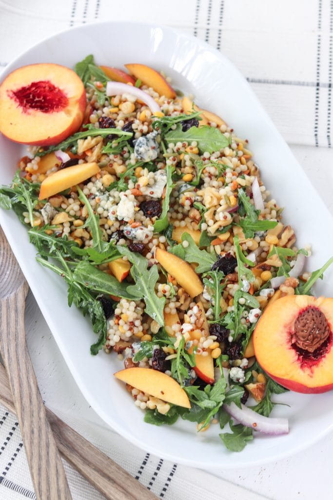 couscous and blue cheese on a plate with peaches.