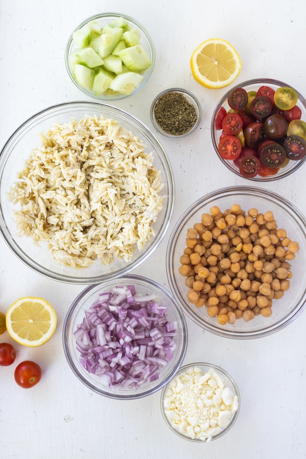 This Greek Orzo Salad is full of fresh, bright ingredients with Middle Eastern spices. A great vegetarian option for meal prep or potluck. | Mealswithmaggie.com #greekorzosalad #mealpreplunch #vegetarian #easygreeksalad  #easypastasalad #pastasalad #greekpastasalad