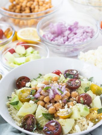 This Greek Orzo Salad is full of fresh, bright ingredients with Middle Eastern spices. A great vegetarian option for meal prep or potluck. | Mealswithmaggie.com #greekorzosalad #mealpreplunch #vegetarian #easygreeksalad  #easypastasalad #pastasalad #greekpastasalad