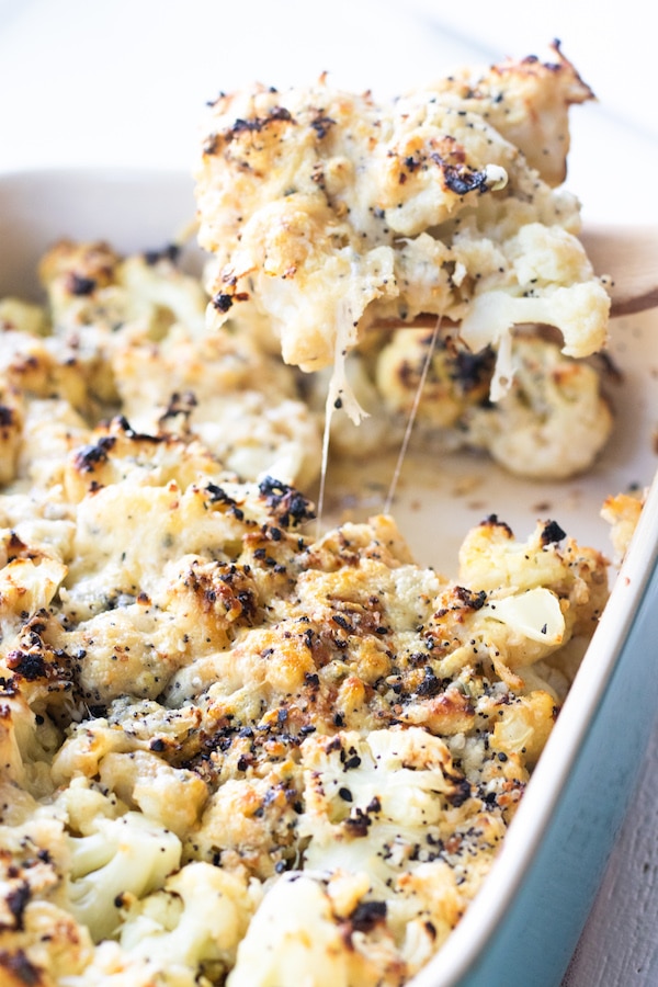 Cauliflower being pulled away from the casserole dish.