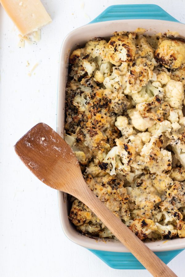 A pan of cauliflower with a spatula. 