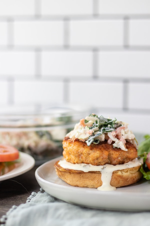 salmon burger on a bun with lettuce on top. 