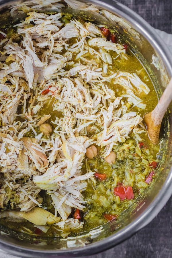 instant pot bowl with shredded chicken and ingredients with spoon 