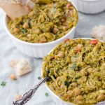 bowls of curry next to each other with bread and spoons coming out of them.