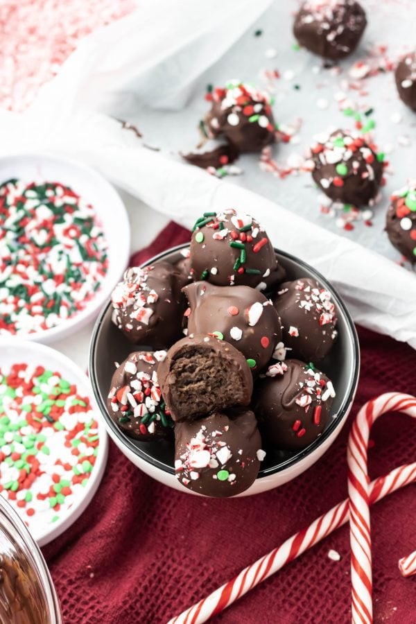 A bowl of chocolate peppermint truffles with sprinkles. 