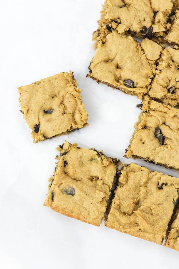 Healthy Peanut Butter Blondies spread out on a baking sheet cut into squares
