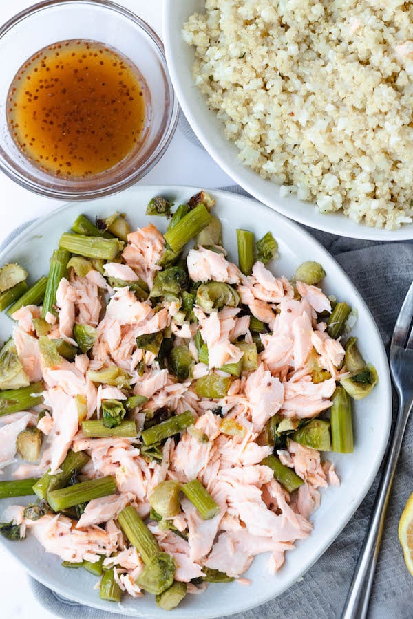 salmon and vegetables on a plate with a fork