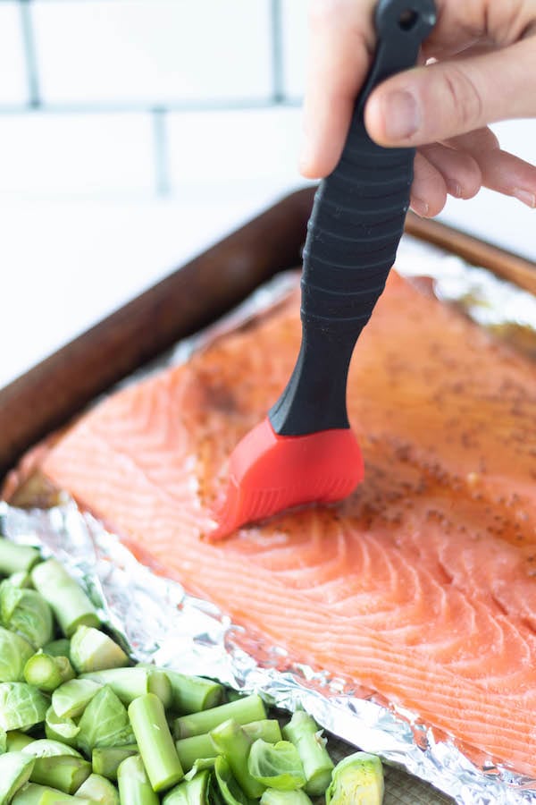 salmon with maple glaze being brushed on