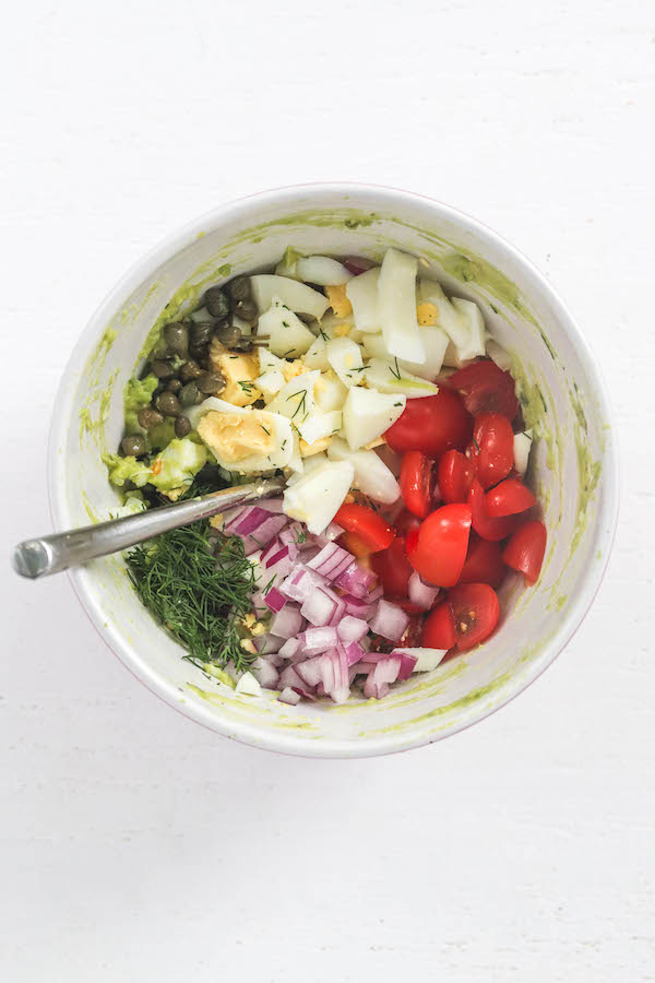 All of the avocado egg salad ingredients in a bowl separately