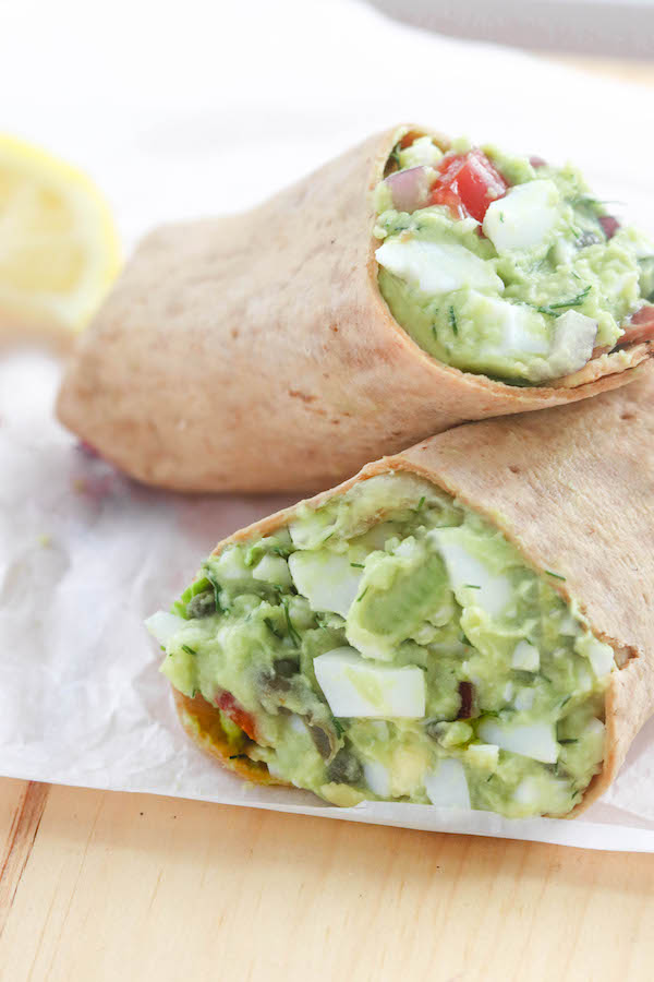 Avocado egg salad on a counter in a multi-grain wrap. 