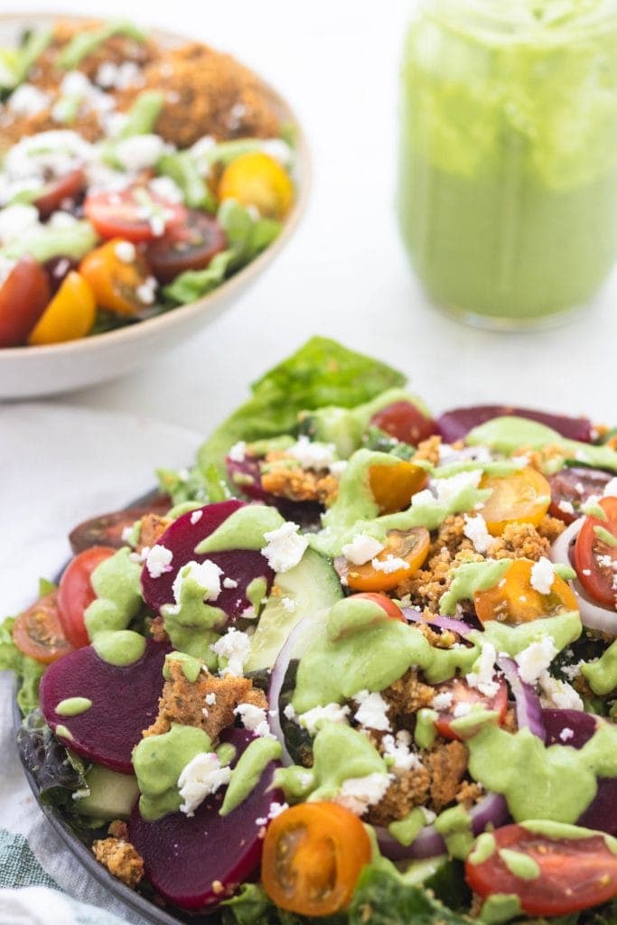 Green goddess greek power salad bowl with toppings. 