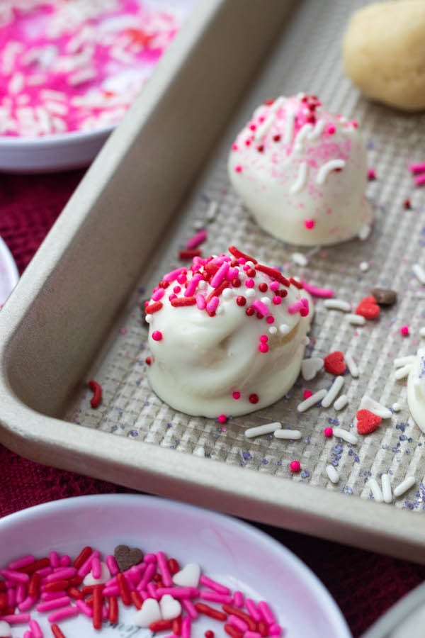 Sugar cookie bite with sprinkles on a sheet pan