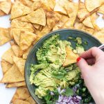 bowl of guacamole with chips