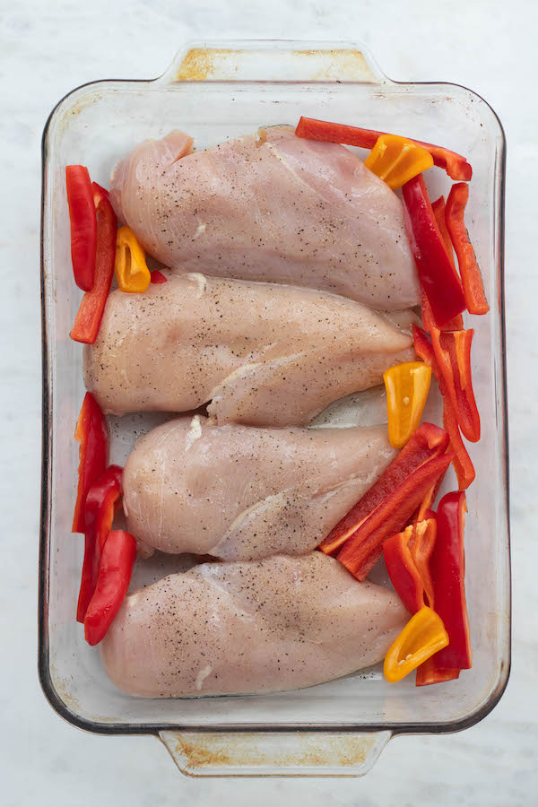 raw chicken in dish with peppers