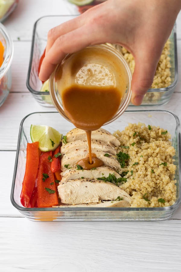 Thai Peanut Chicken meal prep bowl with sauce poured