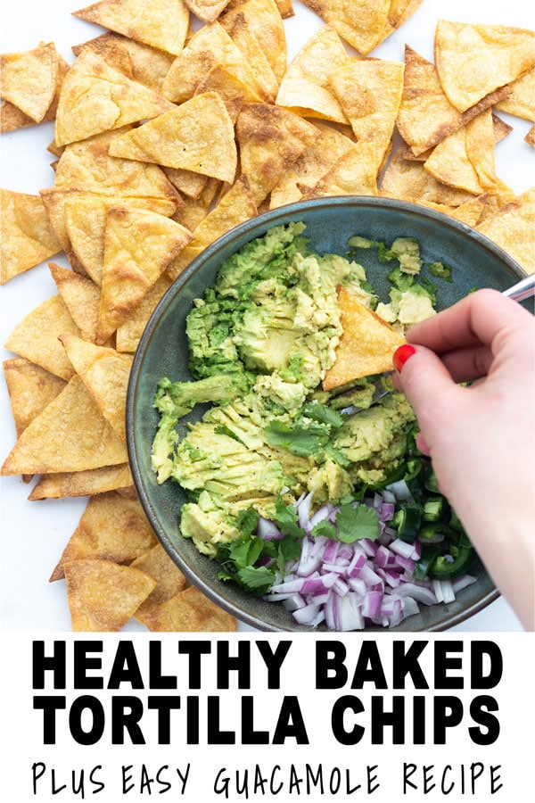 guacamole in a bowl with a chip dipping into it