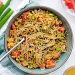 Soba noodle salad with fork sticking out of the bowl.