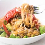 Instant pot stuffed peppers with a cheese pull on a fork.