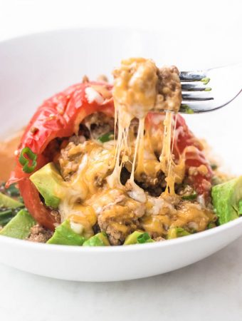 Instant pot stuffed peppers with a cheese pull on a fork.