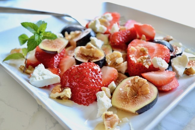 strawberries and other fruit on a plate. 