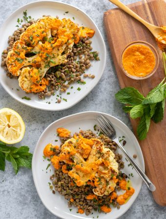 Cauliflower on a plate with lentils, capers and mint.