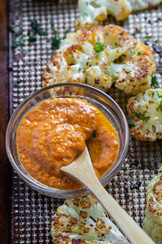 red pepper sauce in a small dish with a spoon.