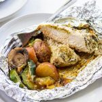 a foil packet with chicken and vegetables in it.