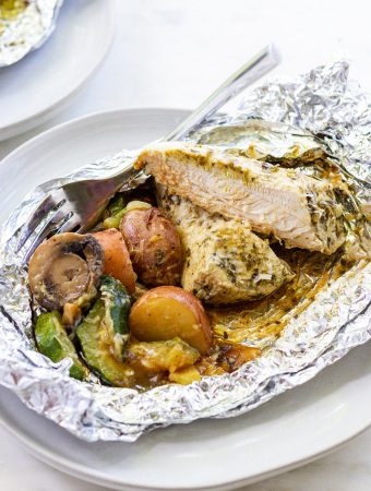 a foil packet with chicken and vegetables in it.