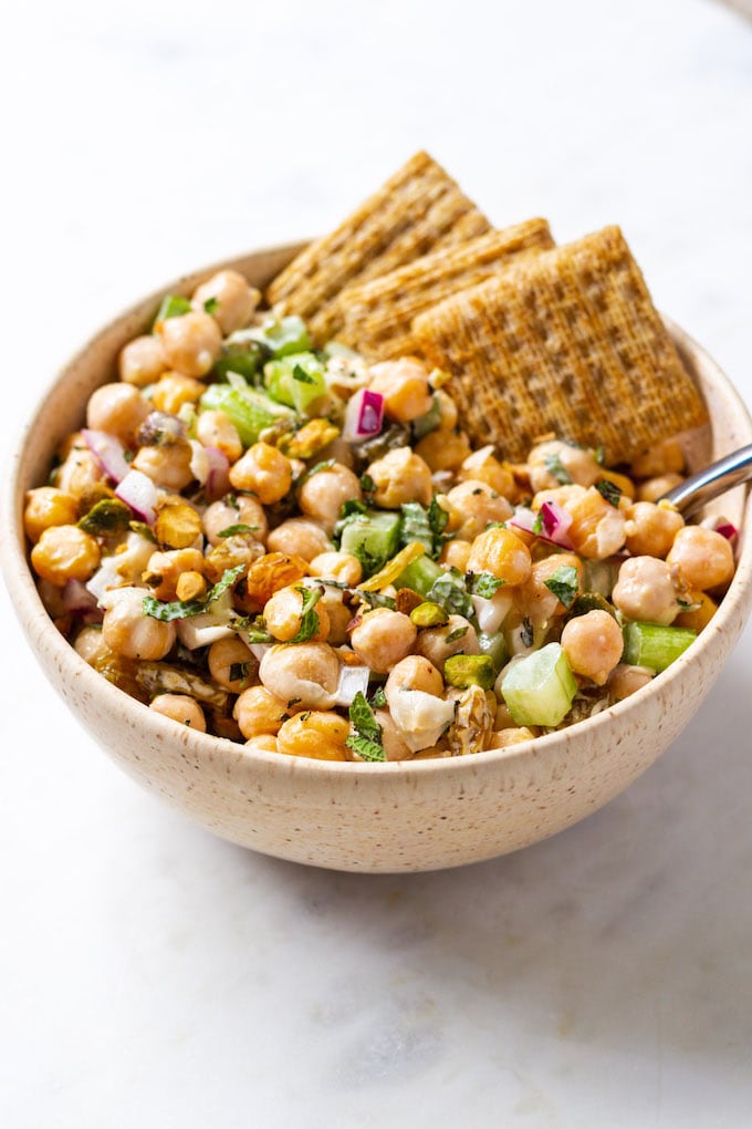 chickpea salad in a bowl with crackers.