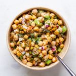 Salad in a bowl with a fork coming out of it.