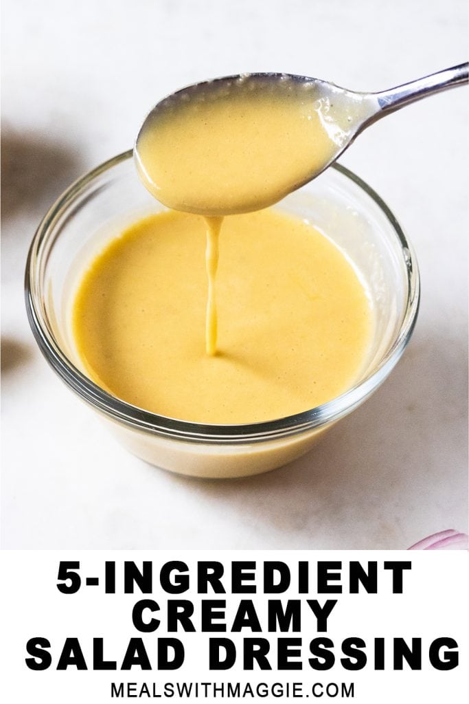 Salad dressing in a bowl with a spoon pouring it.