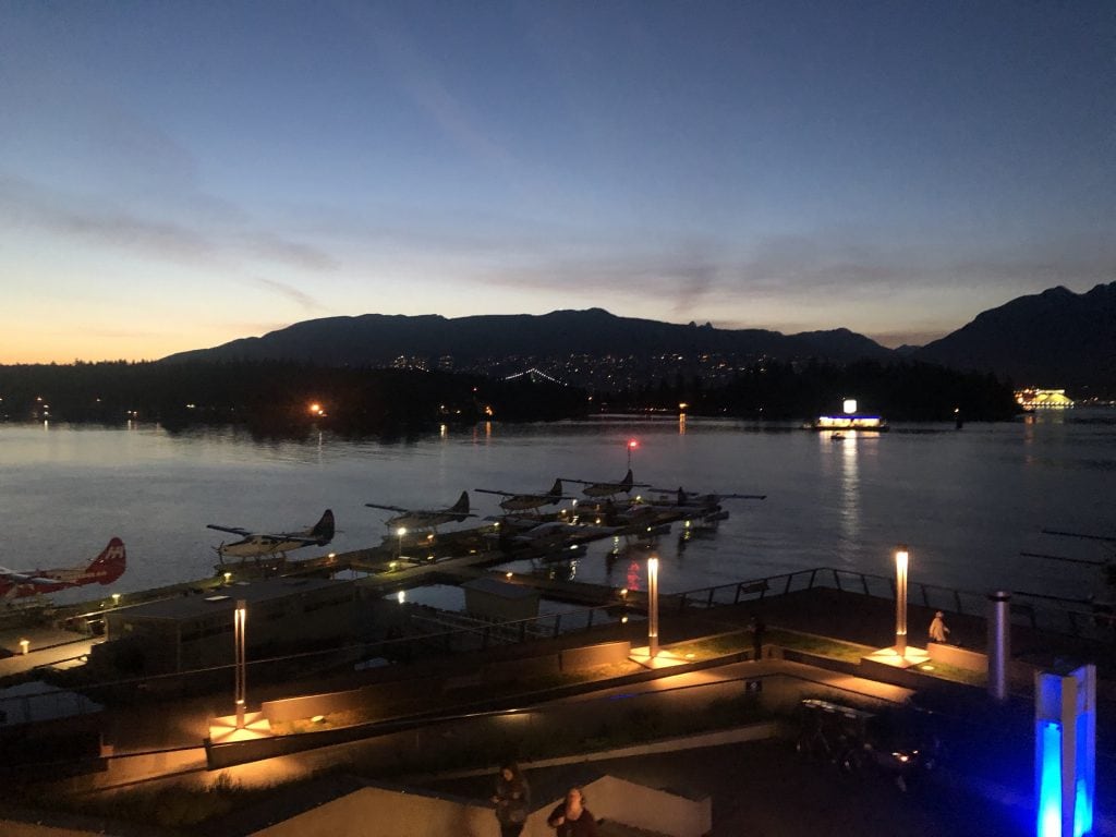 seaplanes docked at night in Vancouver.