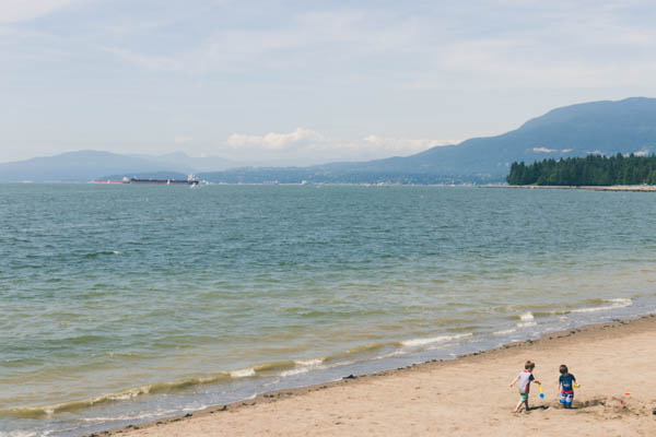Vancouver Stanley Park Beach with mountains in the background.