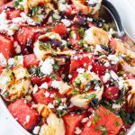 Watermelon feta salad in a bowl with toppings