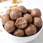 A bowl of protein balls with bite mark in one.