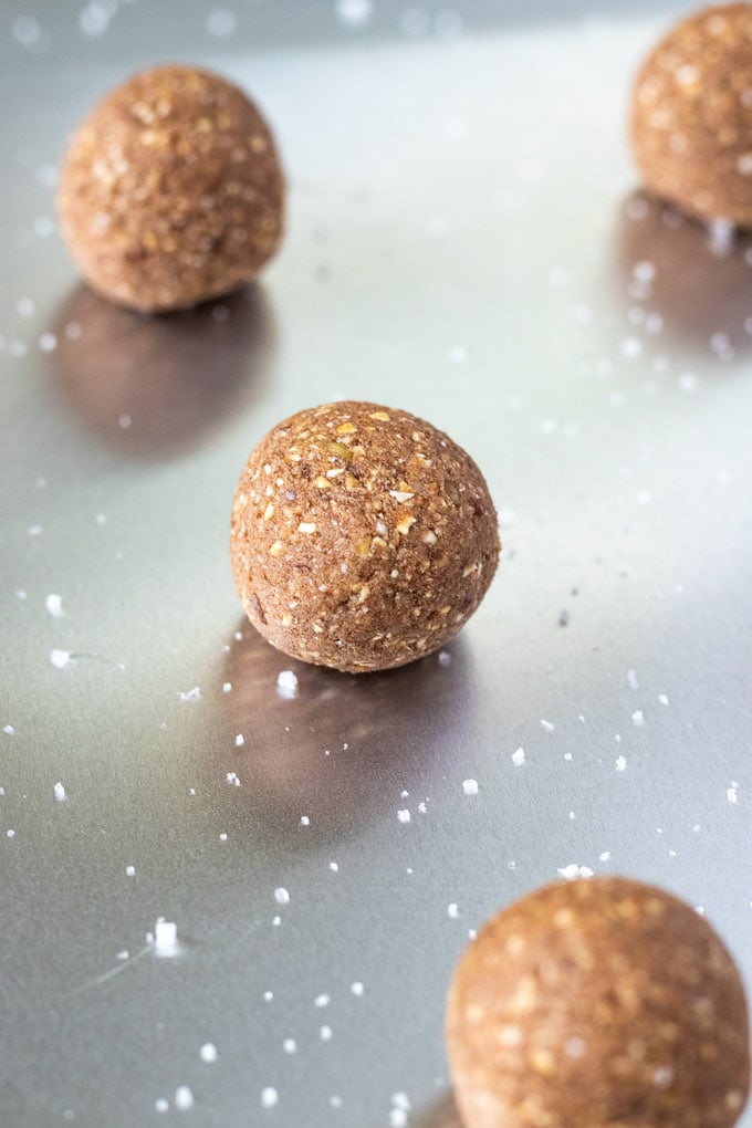 chocolate ball on a sheet pan with salt sprinkled around it.