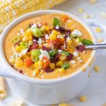 Chicken corn chowder in a bowl with a spoon.