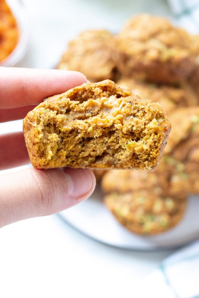 Hand holding the inside of a pumpkin muffin.