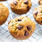 zucchini pumpkin muffins on a cooling rack with text.