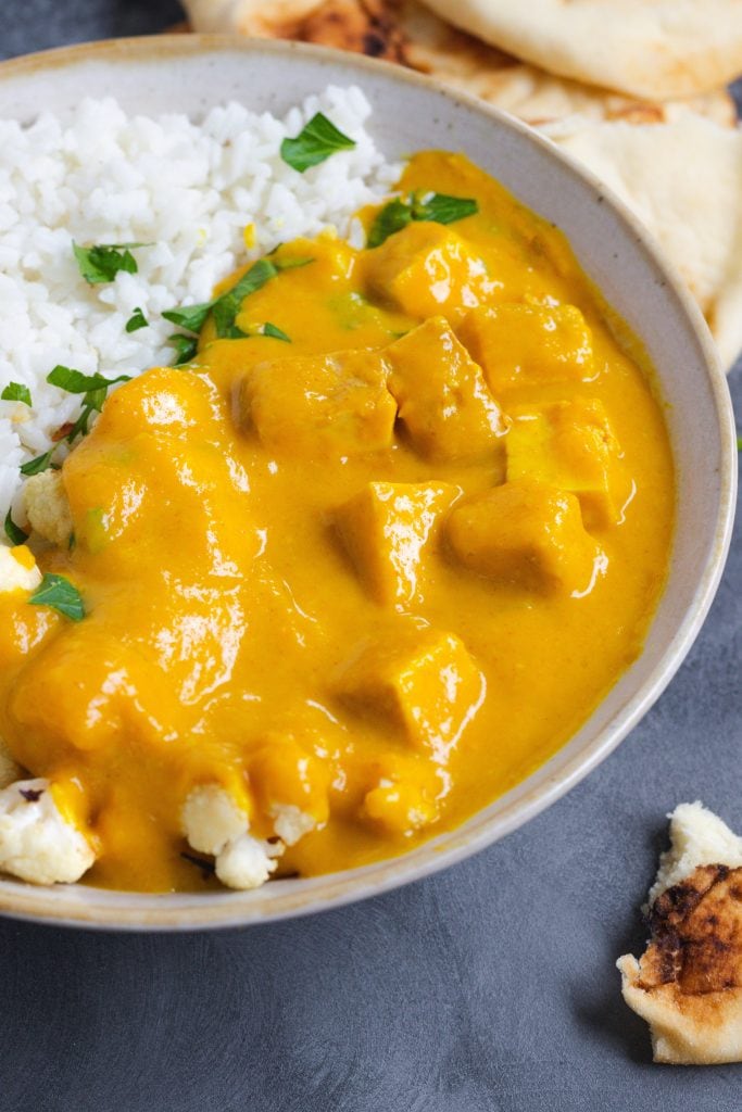 Cauliflower curry in a bowl with tofu. 