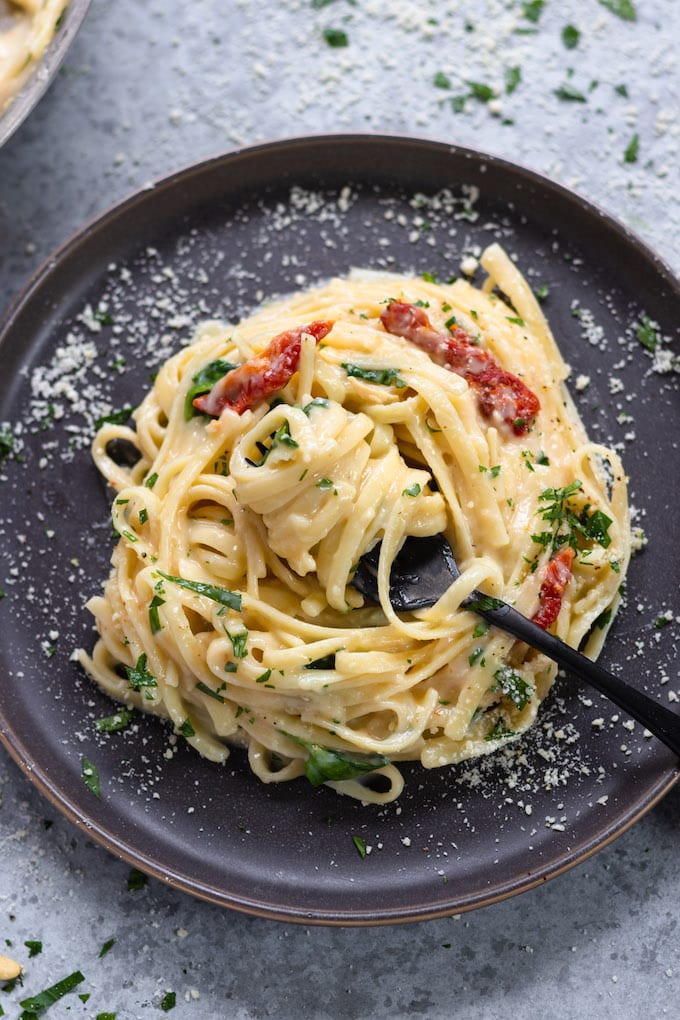 a plate of pasta with a fork. 