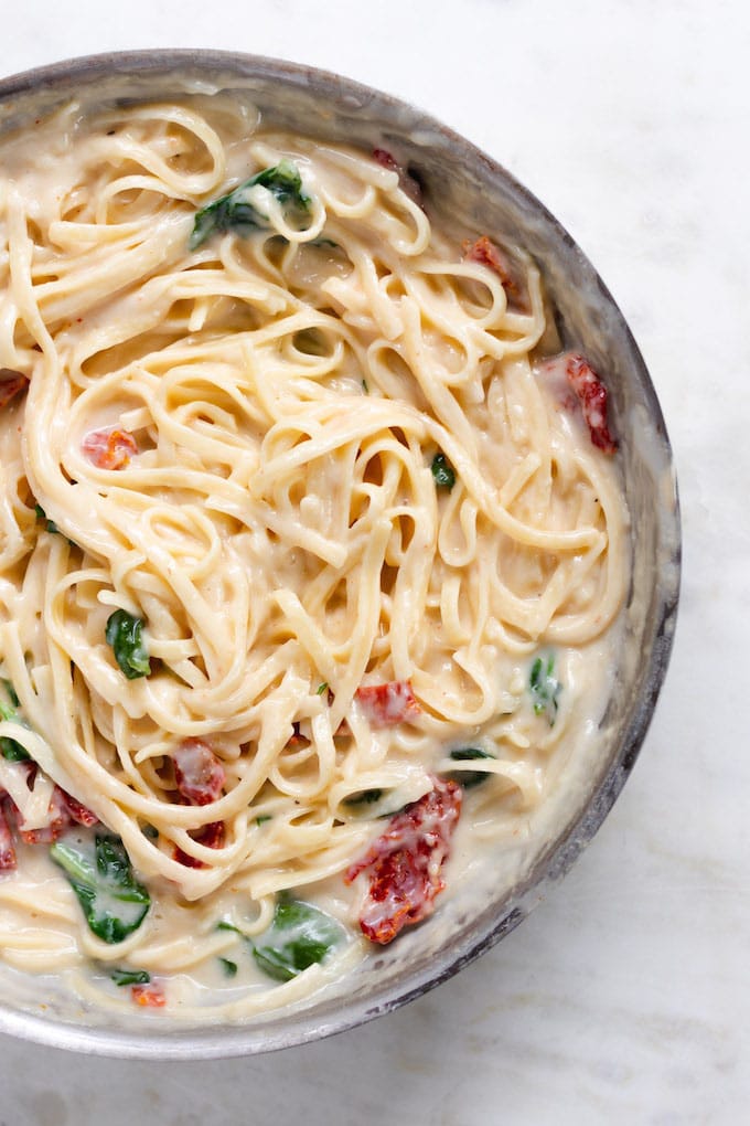 Creamy Alfredo Sauce with pasta and sun dried tomatoes in it.