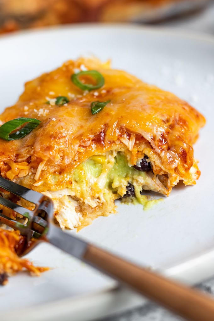 A piece of lasagna with avocado cream coming out. 