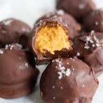 A group of chocolate truffles with pumpkin inside.