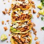 tacos in a line stuffed with salmon.