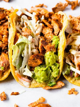 a tortilla with salmon and avocado pineapple guacamole.